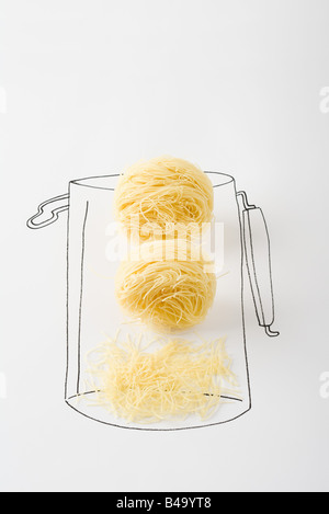 Noodles in canister, broken pieces at the bottom Stock Photo