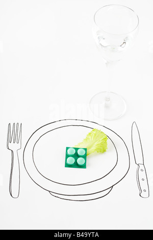 Pills and single leaf of lettuce on drawing of plate Stock Photo