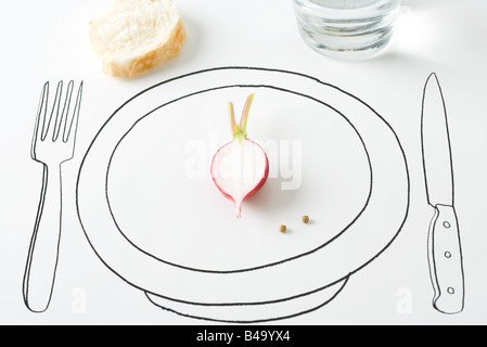 Half a radish and two peppercorns on plate, bread nearby Stock Photo