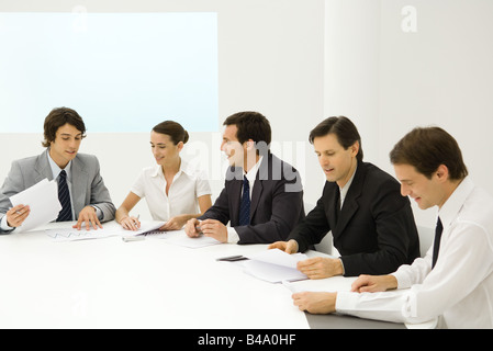 Business people in meeting, reviewing documents Stock Photo
