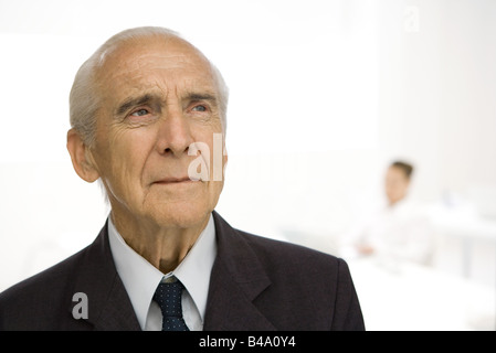 Senior man furrowing brow, looking away Stock Photo