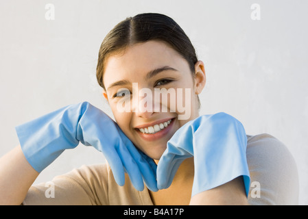 Young woman wearing rubber gloves portrait Stock Photo - Alamy