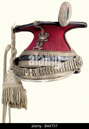 A model 1864/73 Uhlan officer's czapka., Crimson coloured cloth cover, leather body with silver Polish stitching. Leather top, silver cord and front rail replaced when converted. Silk lining. There is the hallmark for 13 -löthige (.8125) silver on the metal chinscales. Officer's insignia, and silver officer's cap lines. Slight moth damage to the cover. Silver lace pieces only moderately darkened. Overall beautiful condition. historic, historical, 19th century, Bavaria, Bavarian, German, Germany, Southern Germany, the South of Germany, object, objects, stills, m, Stock Photo