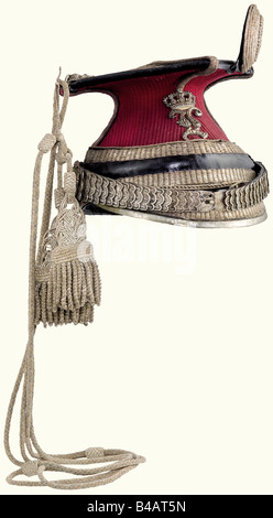 A model 1864/73 Uhlan officer's czapka., Crimson coloured cloth cover, leather body with silver Polish stitching. Leather top, silver cord and front rail replaced when converted. Silk lining. There is the hallmark for 13 -löthige (.8125) silver on the metal chinscales. Officer's insignia, and silver officer's cap lines. Slight moth damage to the cover. Silver lace pieces only moderately darkened. Overall beautiful condition. historic, historical, 19th century, Bavaria, Bavarian, German, Germany, Southern Germany, the South of Germany, object, objects, stills, m, Stock Photo