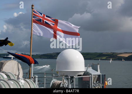 White Ensign flag flying on stern of Royal Navy mine sweeper Falmouth Cornwall UK Stock Photo