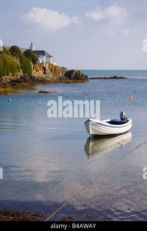 Small boat in bay on rocky coastline in AONB. Bull Bay (Porth Llechog), Isle of Anglesey, North Wales, UK Stock Photo