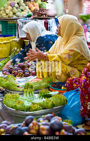 Asia, Malaysia, Kelantan State, Kota Bharu, women selling fruit and vegetables in the town market Stock Photo