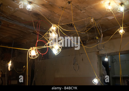 A tangle of electric lights are strung together on the ceiling of a West End restaurant  construction site in London's Soho