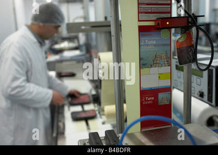 An employee of fish importers New England Seafoods monitors the labelling of supermarket order of fresh Maldives yellowfin tuna Stock Photo