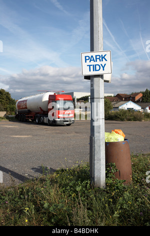 By a full rubbish bin, sign on lamp post telling HGV drivers to park their lorries tidily in overnight lorry park, Grays Essex Stock Photo