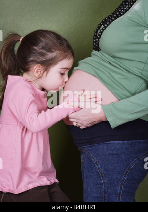 Mother kisses pregnant daughter's belly Stock Photo: 56513958 - Alamy