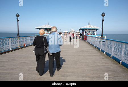 Couple walking along Llandudno Pier, Wales Stock Photo