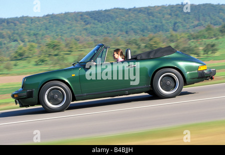 Car, Porsche 911 SC Convertible, model year 1983-1989, this vehicle: model year 1985, open top, dark green, FGUJ, driving, side Stock Photo