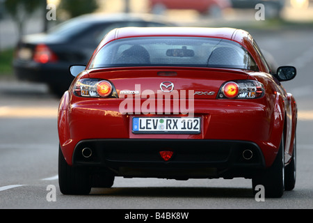 Car, Mazda RX 8, roadster, model year 2002-, red, coupe/Coupe, FGHDS, driving, diagonal from the back, rear view, City Stock Photo
