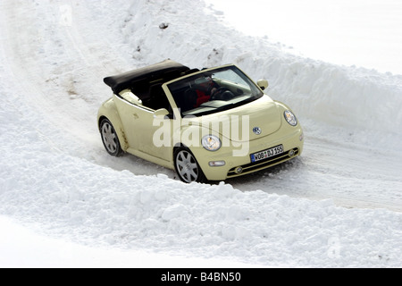 Car, VW Volkswagen New Beetle Convertible, model year 2003-, creme, open top, Winter, Snow, FGHDS, driving, diagonal from the fr Stock Photo