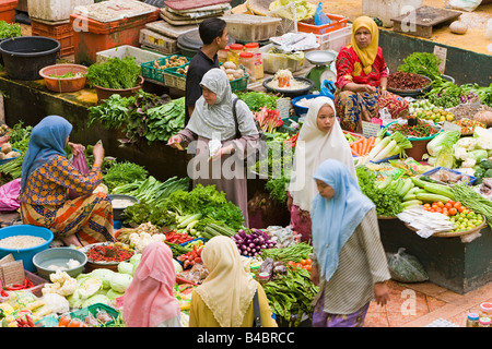 Asia, Malaysia, Kelantan State, Kota Bharu, Women selling fruit and vegetables in the towns central market Stock Photo