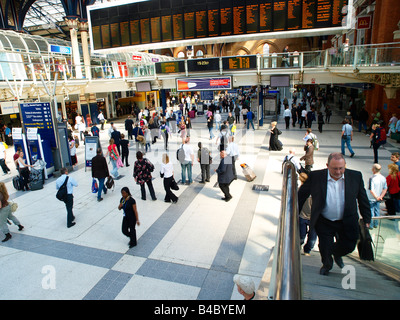 Commuters waiting and watching the departure board at Liverpool Street Railway Station London England Stock Photo