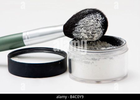 Translucent white powder in a jar and on brush isolated Stock Photo