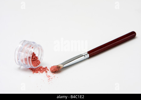 Translucent pink powder in a jar and on brush isolated Stock Photo