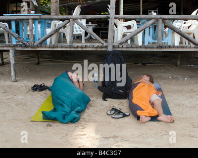 Two guys sleeping rough on the beach Stock Photo