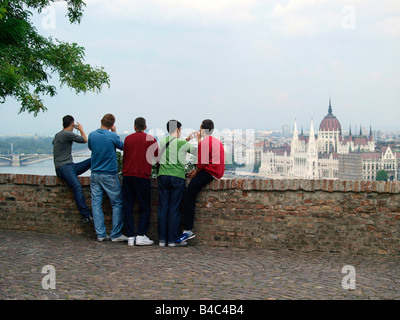 A group of young men taking photographs of the Pest skyline from the Castle Hill in Buda. Stock Photo