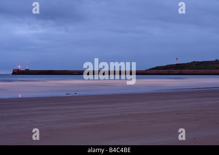 Aberdeen beach just before sunrise, looking towards the lighthouse Stock Photo