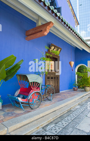 Asia, Malaysia, Penang, Pulau Pinang, Georgetown, Chinatown district, detail of a red Trishaw and traditional Chinese doorway Stock Photo