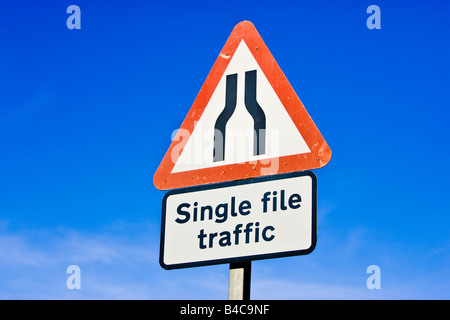 Road sign warning sign of road narrows ahead both sides to single file traffic England UK Stock Photo