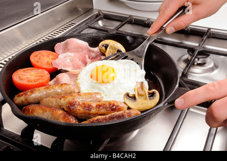 MAN COOKING FRIED BREAKFAST Stock Photo