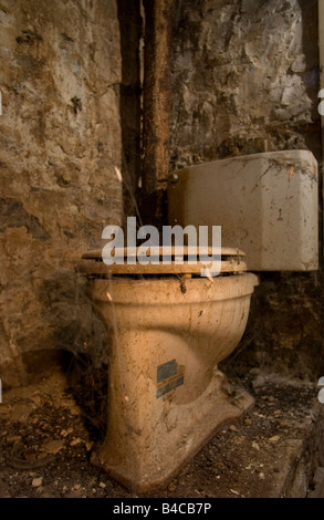 Disgusting dirty toilet in an old dilapidated row house. Stock Photo