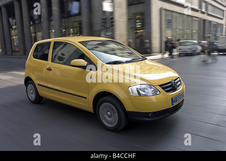 Car, VW Volkswagen Fox, model year 2005-, yellow, Miniapprox.s, Limousine, driving, diagonal from the front, frontal view, side Stock Photo