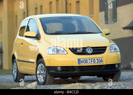 Car, VW Volkswagen Fox, model year 2005-, yellow, Miniapprox.s, Limousine, standing, upholding, diagonal from the front, frontal Stock Photo