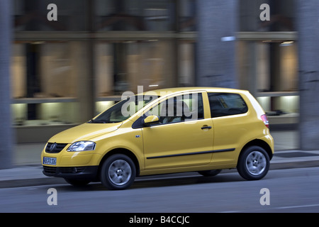 Car, VW Volkswagen Fox, model year 2005-, yellow, Miniapprox.s, Limousine, driving, diagonal from the front, side view, City, ph Stock Photo