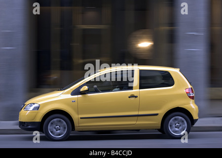 Car, VW Volkswagen Fox, model year 2005-, yellow, Miniapprox.s, Limousine, driving, side view, City, photographer: Achim Hartman Stock Photo