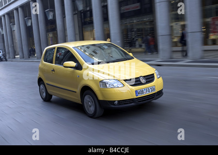 Car, VW Volkswagen Fox, model year 2005-, yellow, Miniapprox.s, Limousine, driving, diagonal from the front, frontal view, City, Stock Photo