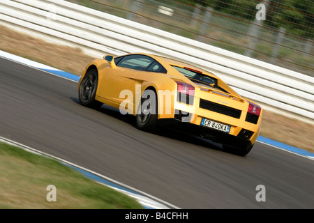 Lamborghini Gallardo, model year 2005-, yellow, driving, diagonal from the back, rear view, Test track Stock Photo