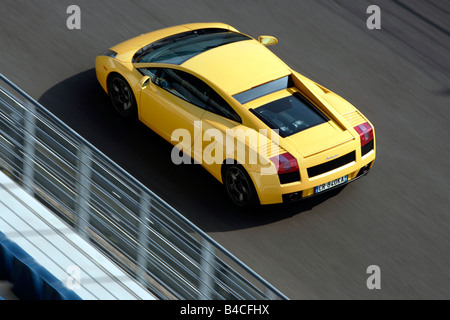 Lamborghini Gallardo, model year 2005-, yellow, driving, diagonal from the back/oben, rear view, Test track Stock Photo