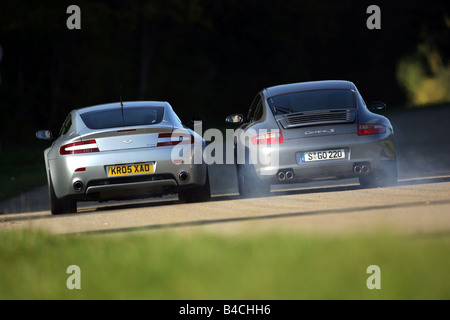 Sports approx.s group picture: Porsche 911 Carrera S, model year 2005-, silver/anthracite, Aston Martin V8 Vantage, Year of cons Stock Photo