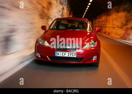 Lexus IS 250, model year 2005-, red, driving, diagonal from the front, frontal view, country road, Mountains, Tunnel Stock Photo