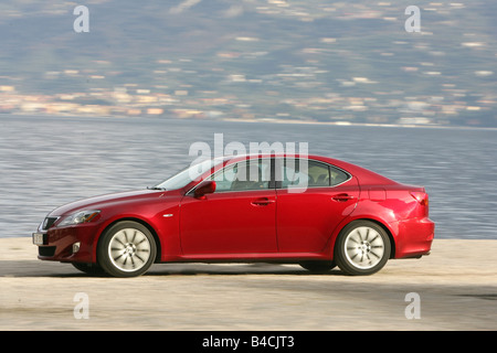 Lexus IS 250, model year 2005-, red, driving, side view, lake Stock Photo