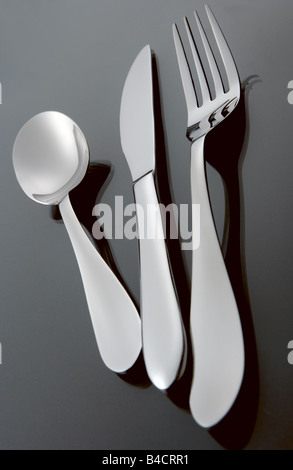 Silver Stainless Steel Cutlery Set on a Graduated Black Background With Reflection Including Knife Fork And Spoon Stock Photo