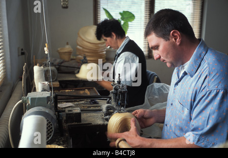 A hat maker and assistent working a home factory in the village of Dobeni or Szekelydobo Transylvania Romania Stock Photo