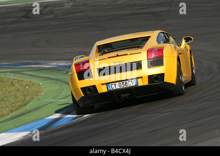 Lamborghini Gallardo, model year 2005-, yellow, driving, diagonal from the back, rear view, Test track Stock Photo