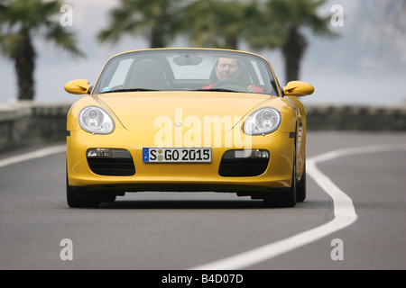 Porsche Boxster Sportpaket, model year 2004-, yellow, driving, diagonal from the front, behind, frontal view, country road, land Stock Photo