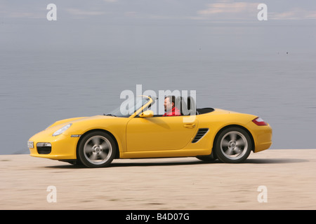 Porsche Boxster Sportpaket, model year 2004-, yellow, driving, side view, Beach, open top Stock Photo