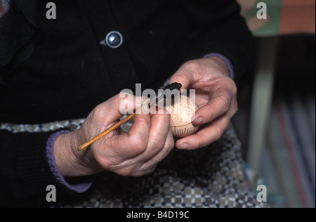 Hand painting chicken eggs used in Easter celebration to sell on a market stall Transylvania Romania Stock Photo