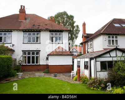 Housing Edwardian back garden and asbestos garage of semi detatched surbuban house in need of updating Stock Photo