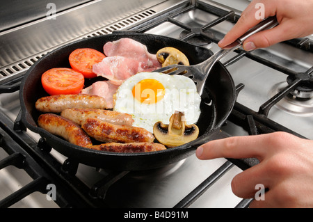 MAN COOKING FRIED BREAKFAST Stock Photo