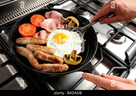 MAN COOKING FRIED BREAKFAST Stock Photo