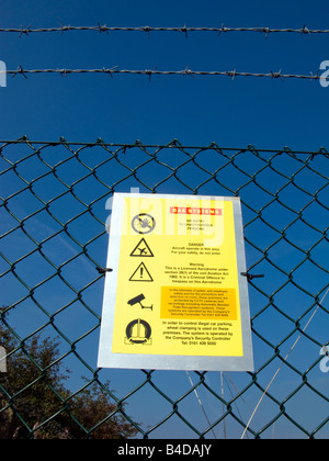 Security Perimeter Sign Security warning sign on the perimeter fence of an industrial unit ...